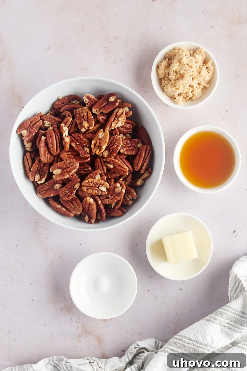 An overhead view of all the simple ingredients laid out for making Glazed Pecans: butter, brown sugar, maple syrup, salt, and raw pecans.
