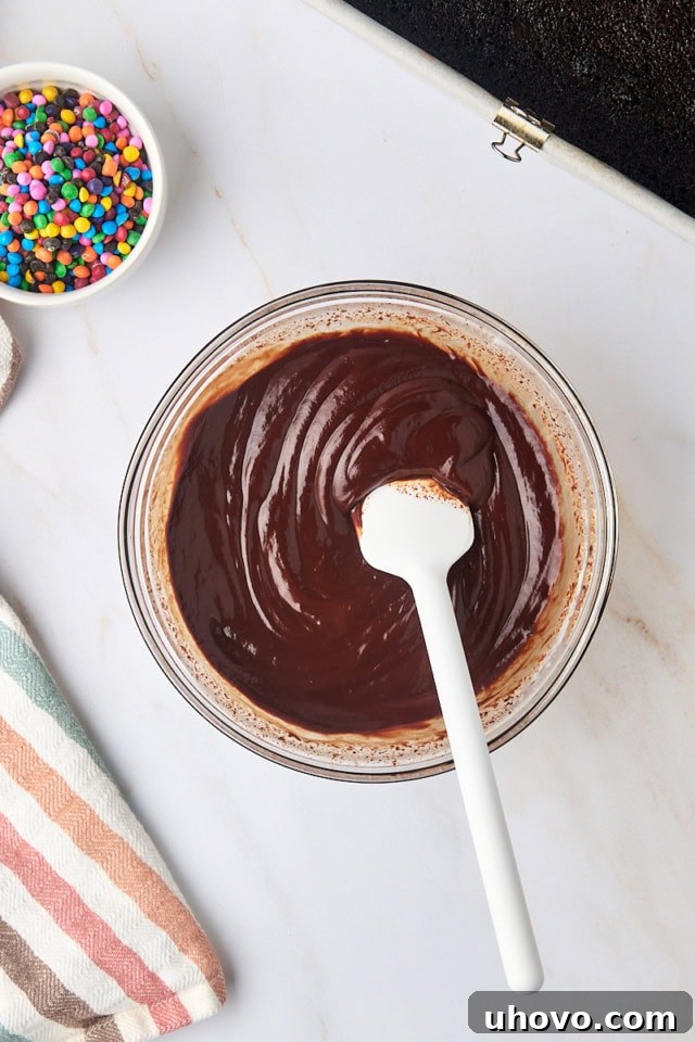 overhead view of chocolate ganache in a glass mixing bowl