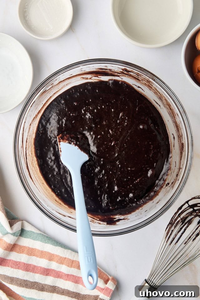 overhead view of brownie batter in a glass mixing bowl