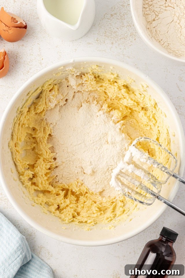 overhead view of dry ingredients added to cake batter