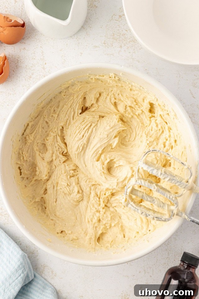 overhead view of cake batter in a white mixing bowl