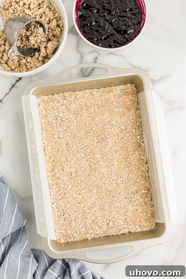 Overhead view of crust in bottom of parchment-lined baking pan