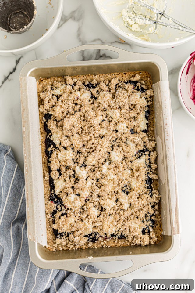 Overhead view of unbaked blueberry jam cream cheese bars in pan