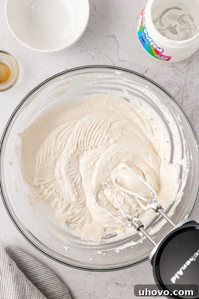 overhead view of marshmallow buttercream in a glass mixing bowl
