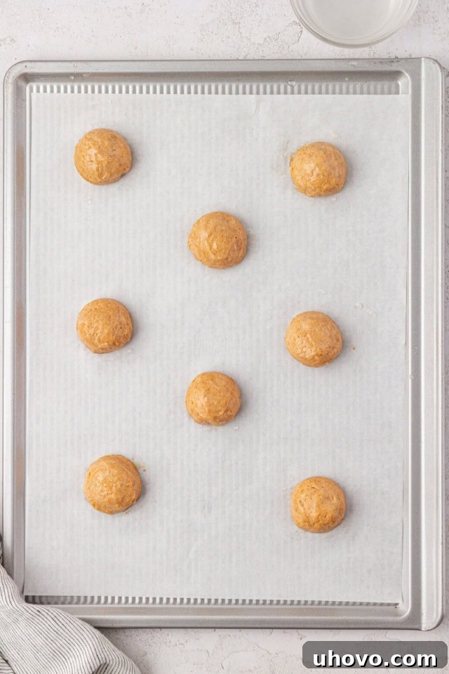 overhead view of portioned graham cake batter on a parchment-lined baking sheet
