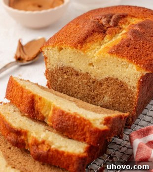 A partially sliced Marbled Cookie Butter Cake, revealing its beautiful swirled texture and inviting aroma.