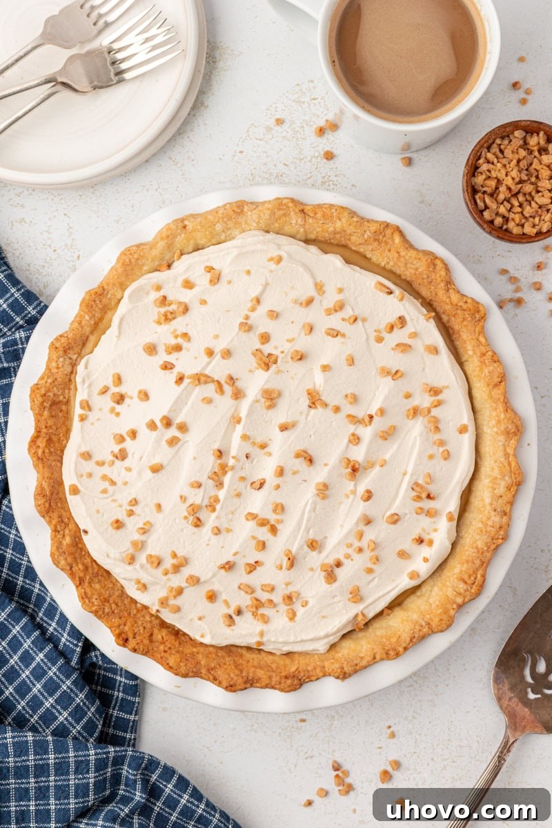 overhead view of butterscotch pie topped with brown sugar whipped cream and toffee bits