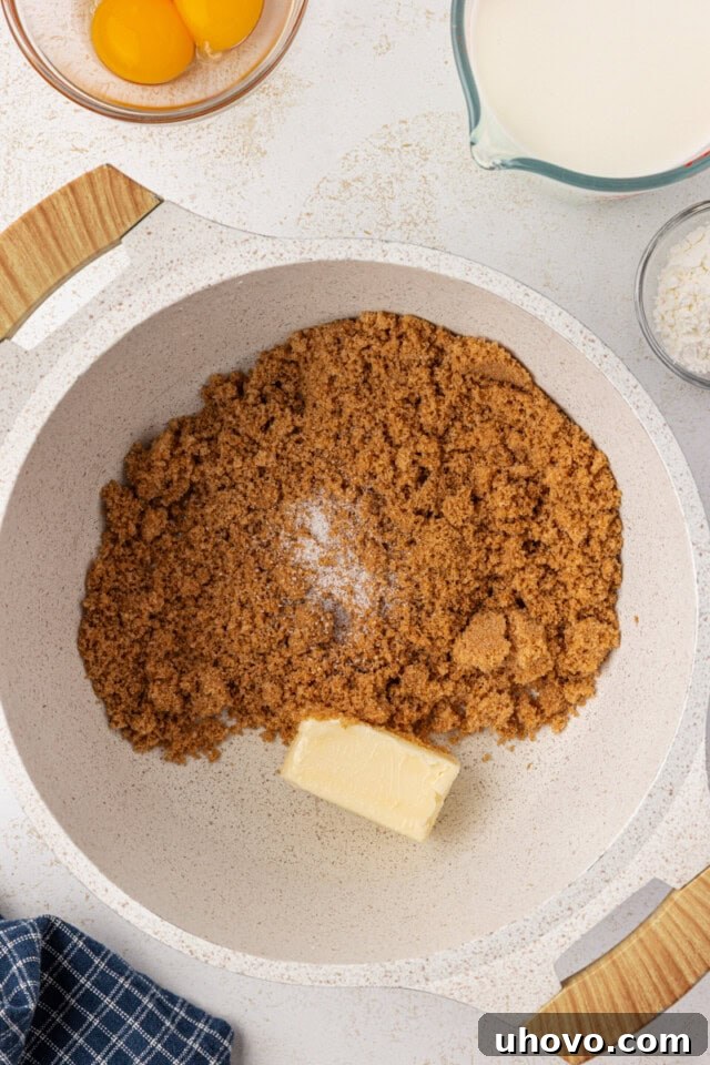 overhead view of butter and brown sugar in a white saucepan