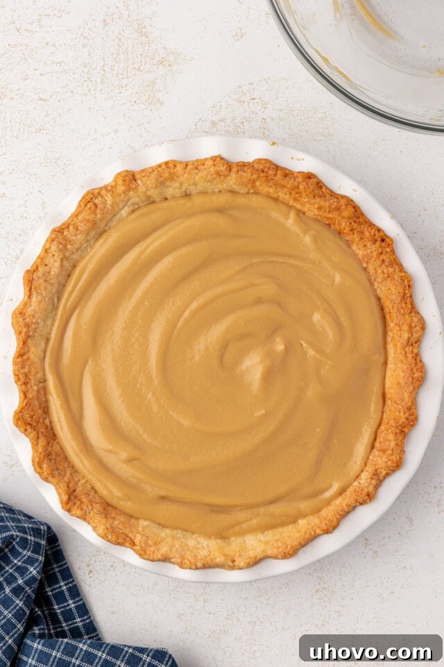 overhead view of butterscotch pie in a white pie plate