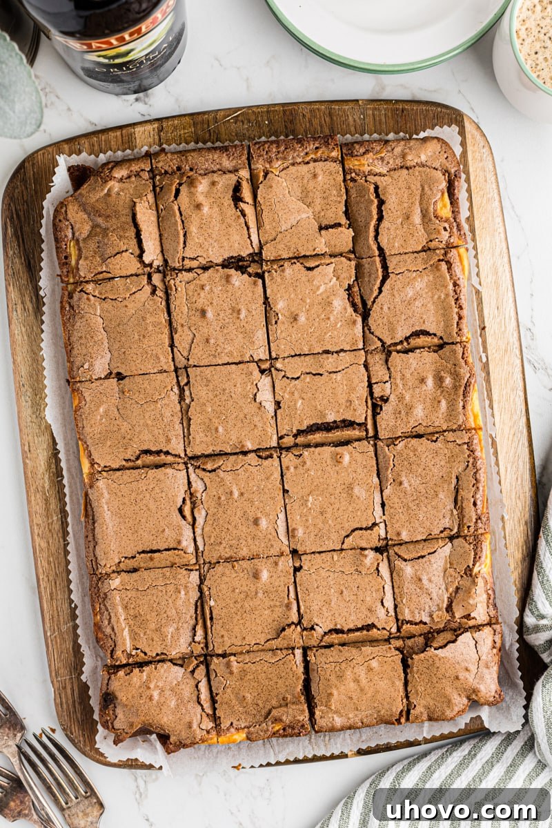 Overhead view of sliced Irish cream brownies on a wooden cutting board.