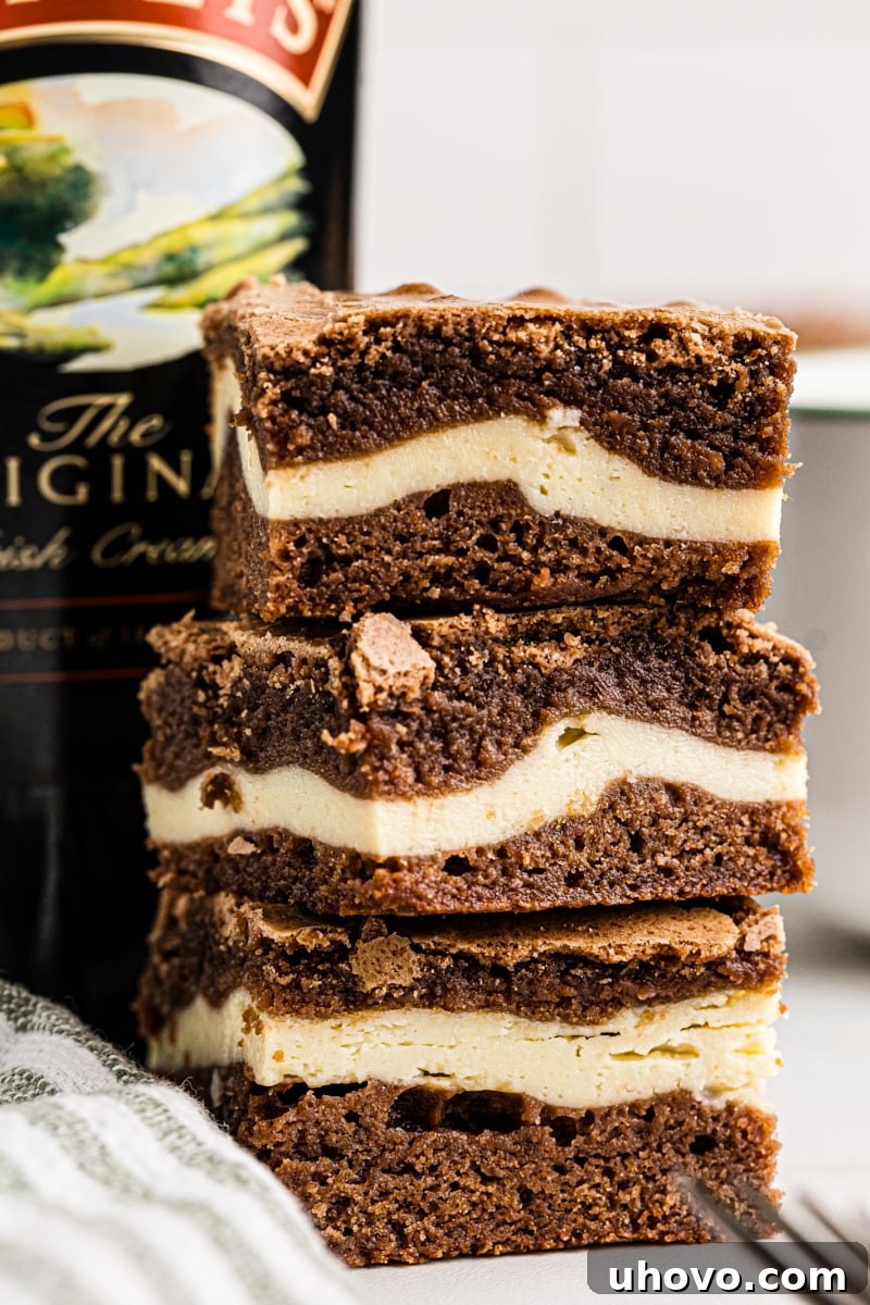 Stack of 3 Irish cream brownies with cream cheese filling visible between the fudgy chocolate layers.