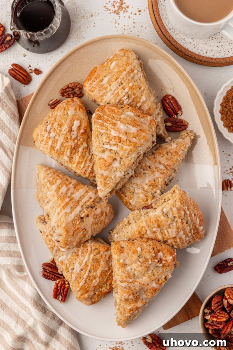 A beautifully arranged oval serving platter showcasing a batch of freshly baked maple pecan scones, each perfectly golden and ready to be enjoyed.