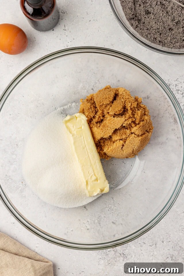 overhead view of butter, sugar, and brown sugar in a glass mixing bowl