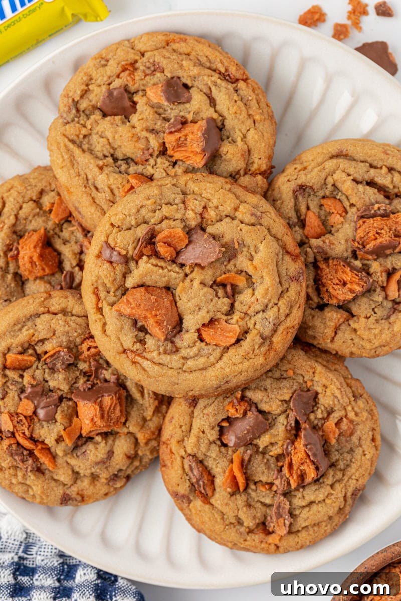 overhead view of Butterfinger cookies in a stacked pile on a white plate