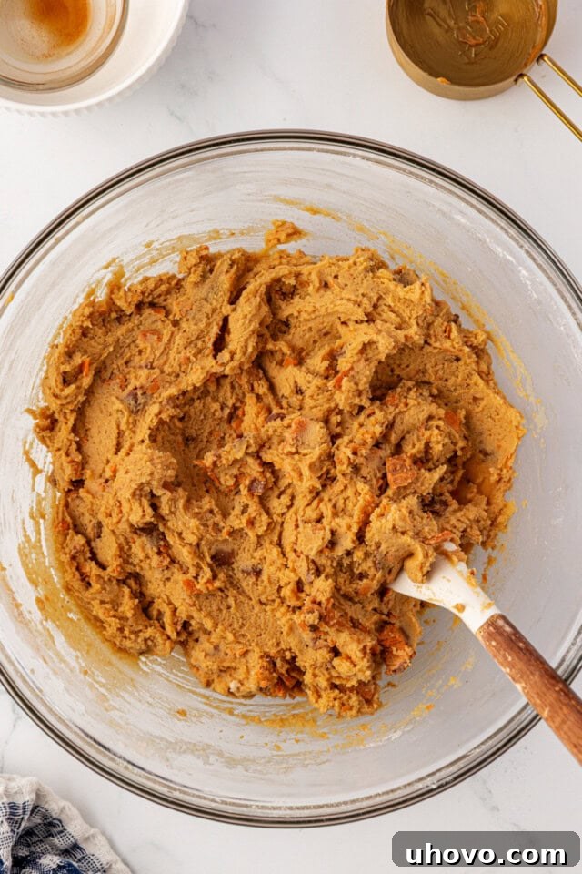 overhead view of Butterfinger cookie dough in a glass mixing bowl