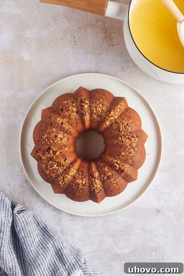 Overhead view of the fully inverted rum cake on a serving platter, before the final glaze application.