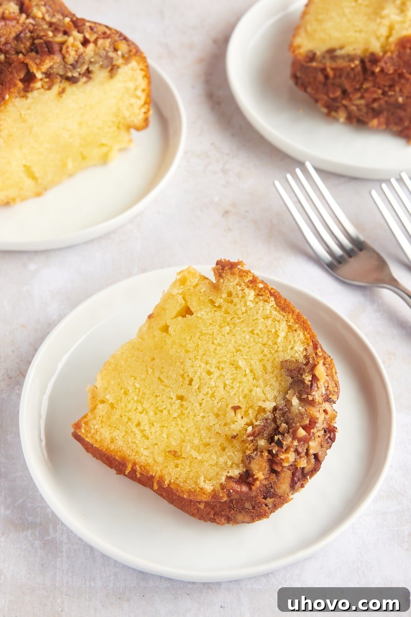 Three individual plates, each holding a luscious slice of rum cake, inviting enjoyment.