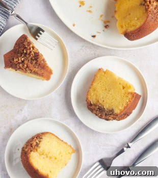 Overhead view of rum cake slices on 3 plates, showcasing its moist texture.