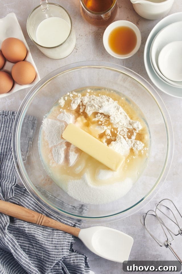 Overhead view of dry ingredients for rum cake batter in a large mixing bowl before liquids are added.