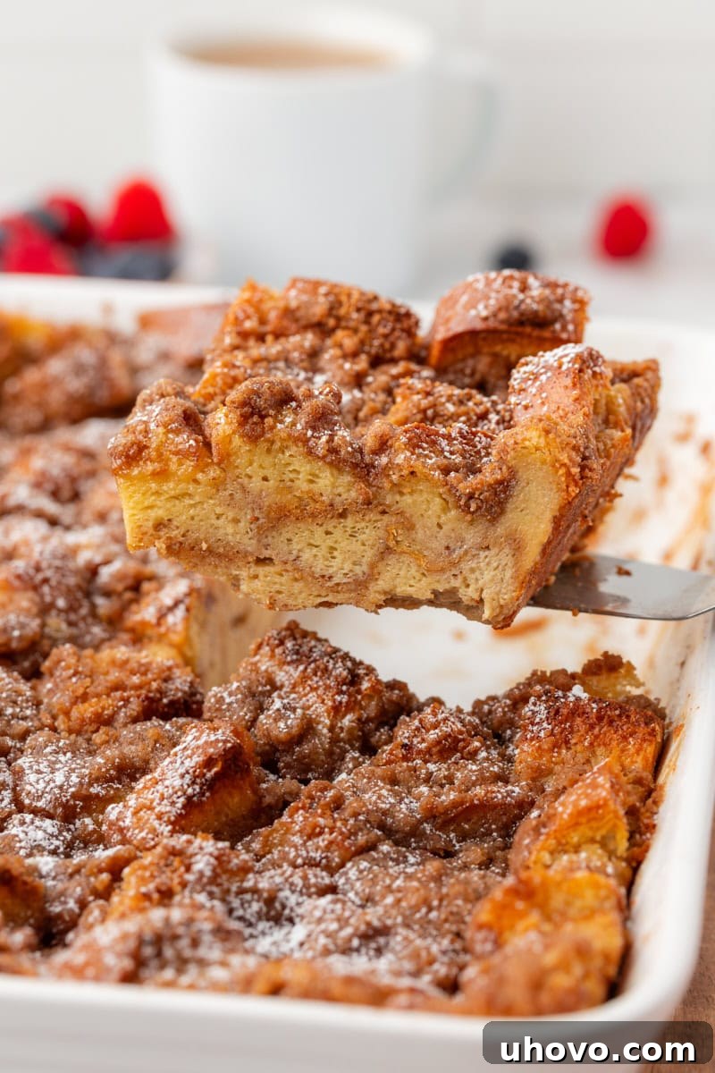 overhead view of a slice of baked French toast being lifted out of the pan