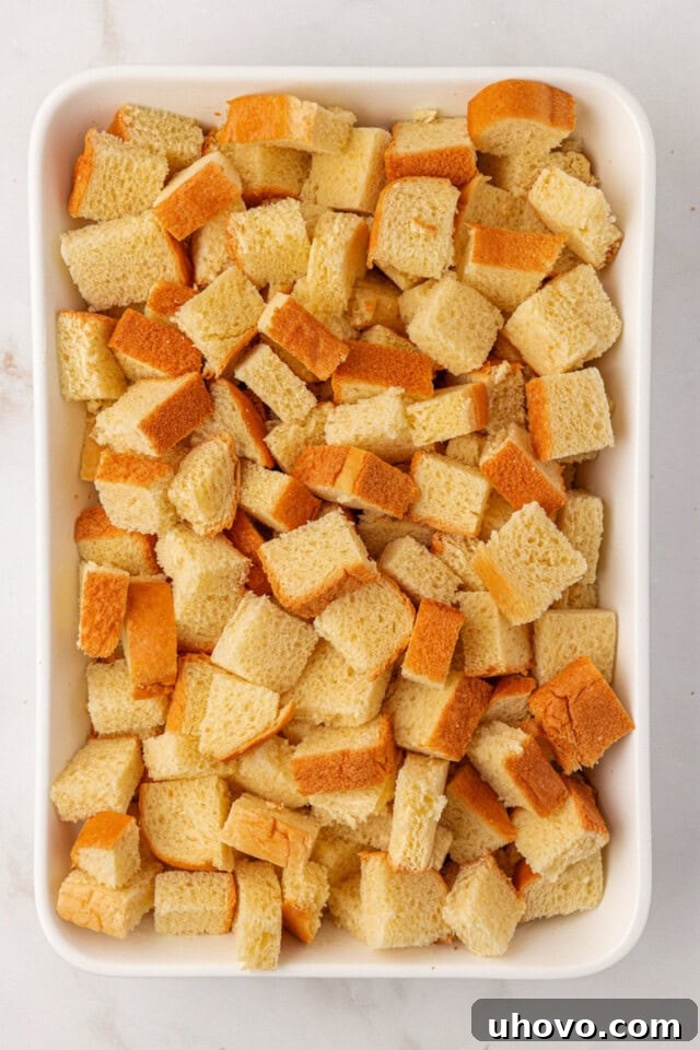 overhead view of cubed bread in a 9x13 pan