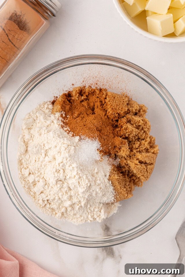 overhead view of brown sugar, flour, cinnamon, and salt i a mixing bowl