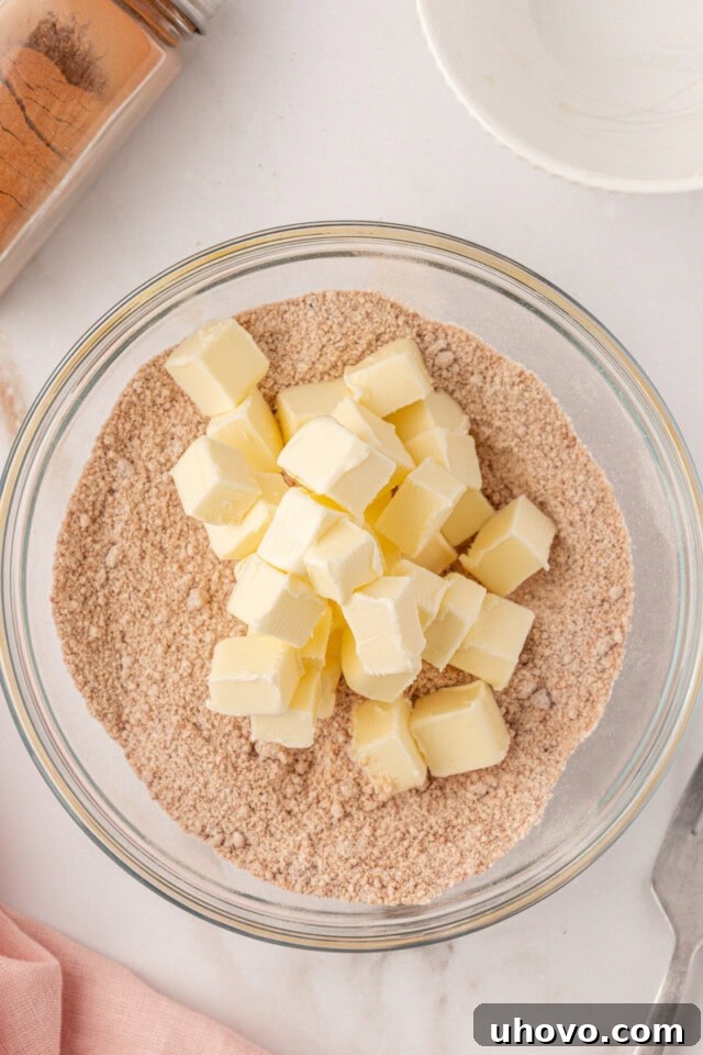 overhead view of butter added to crumb topping mixture