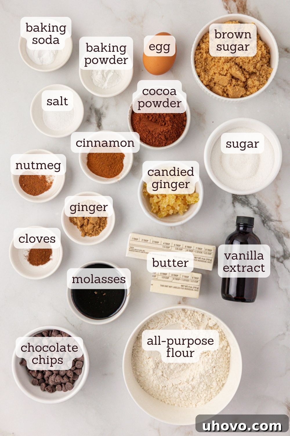 An overhead view showcasing the essential ingredients for making chocolate ginger cookies, neatly arranged on a flat surface.