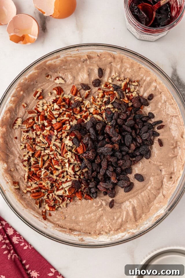 overhead view of chopped nuts and raisins added to Kentucky jam cake batter