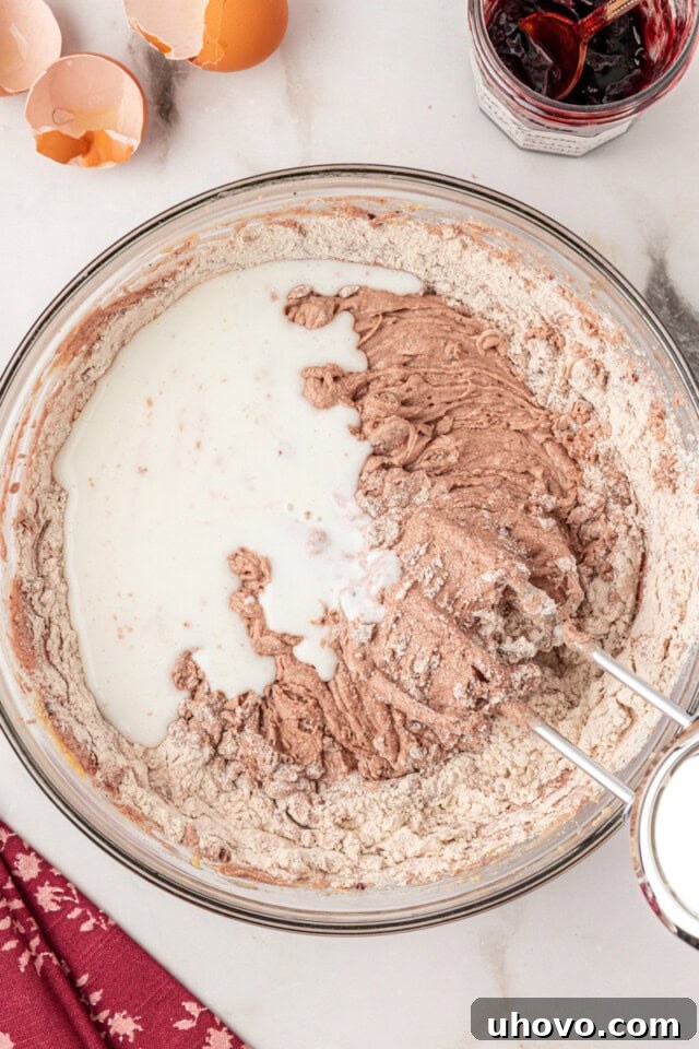 overhead view of buttermilk added to cake batter