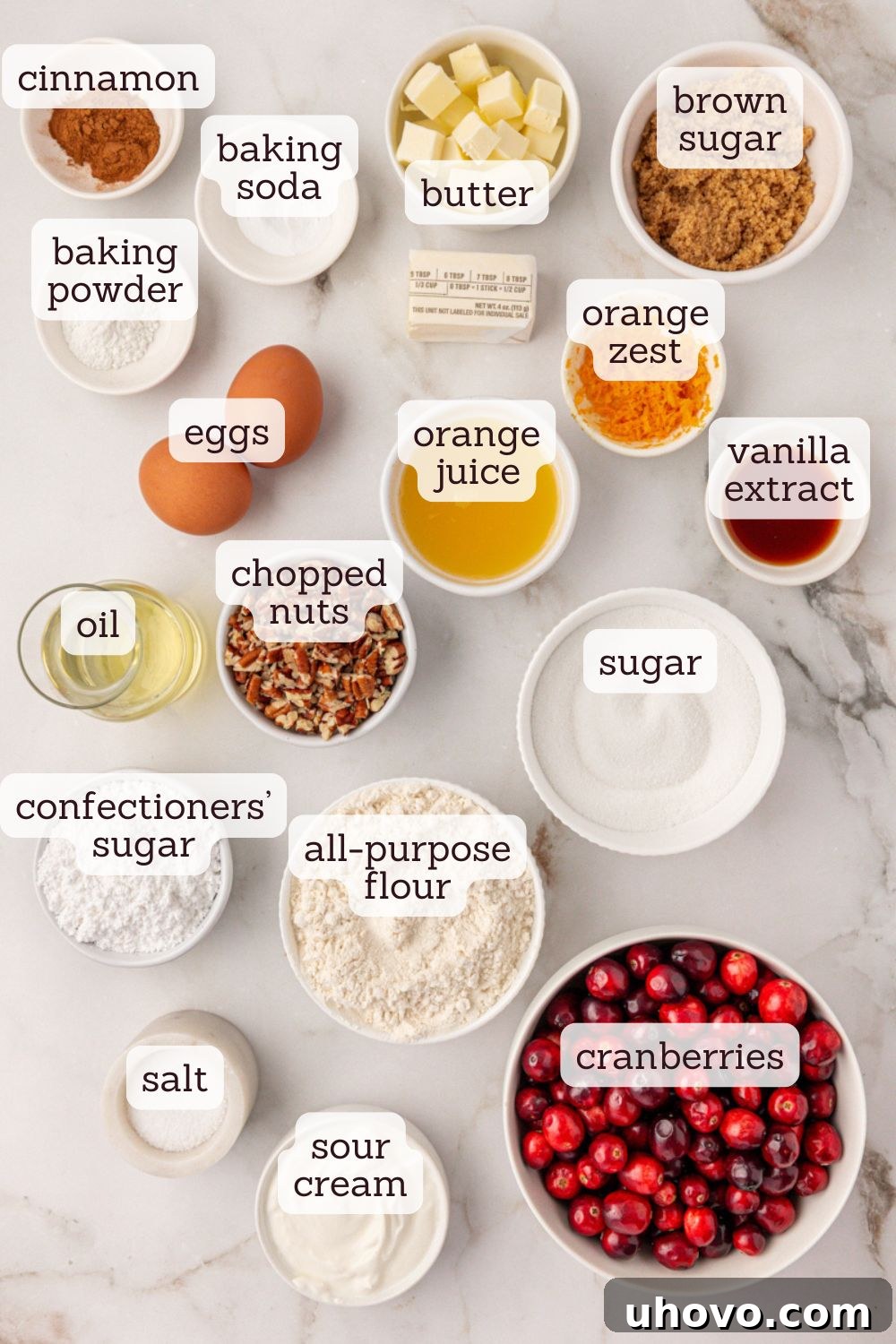 An overhead view showcasing all the key ingredients for making a delicious cranberry coffee cake laid out on a clean surface.