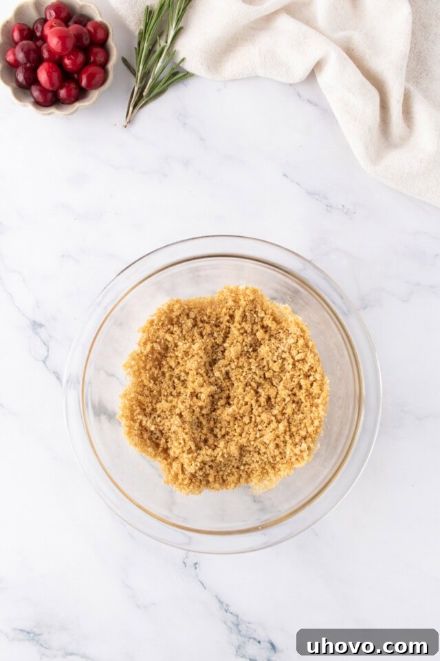 overhead view of graham cracker crust mixture in a small glass bowl