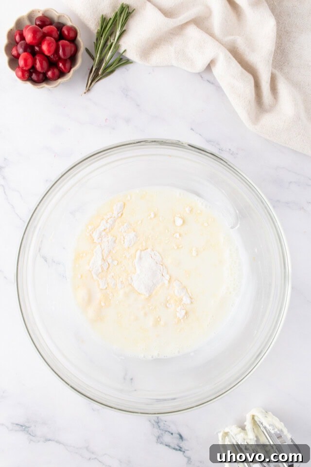 overhead view of pudding mix and milk in a glass mixing bowl