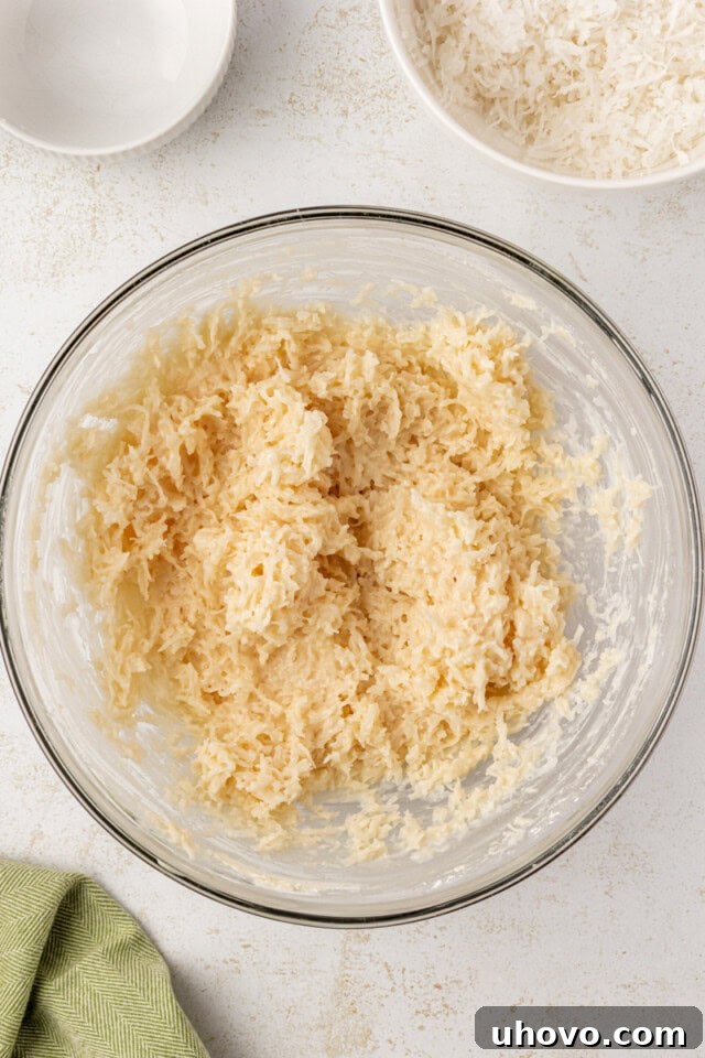 coconut snowballs mixture in a glass mixing bowl