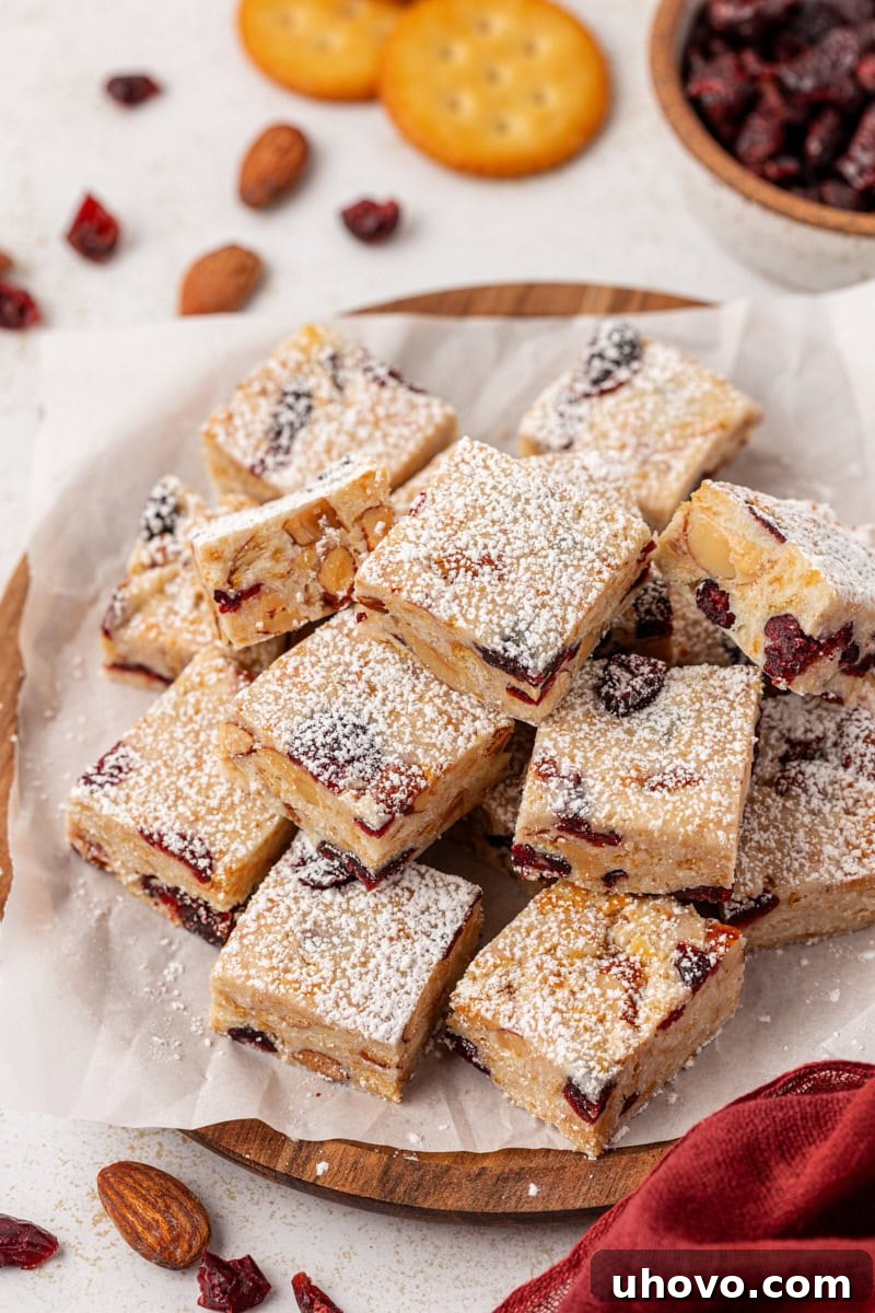 A serving of Snowflake Crisp, elegantly presented on a white plate, highlighting its pristine powdered sugar topping and irresistible texture.
