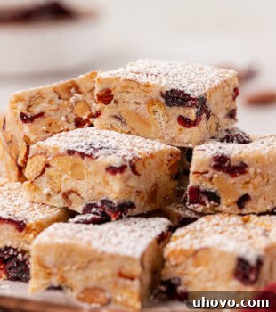 A piled stack of Snowflake Crisp on a wooden serving board, ready to be enjoyed as a holiday treat.