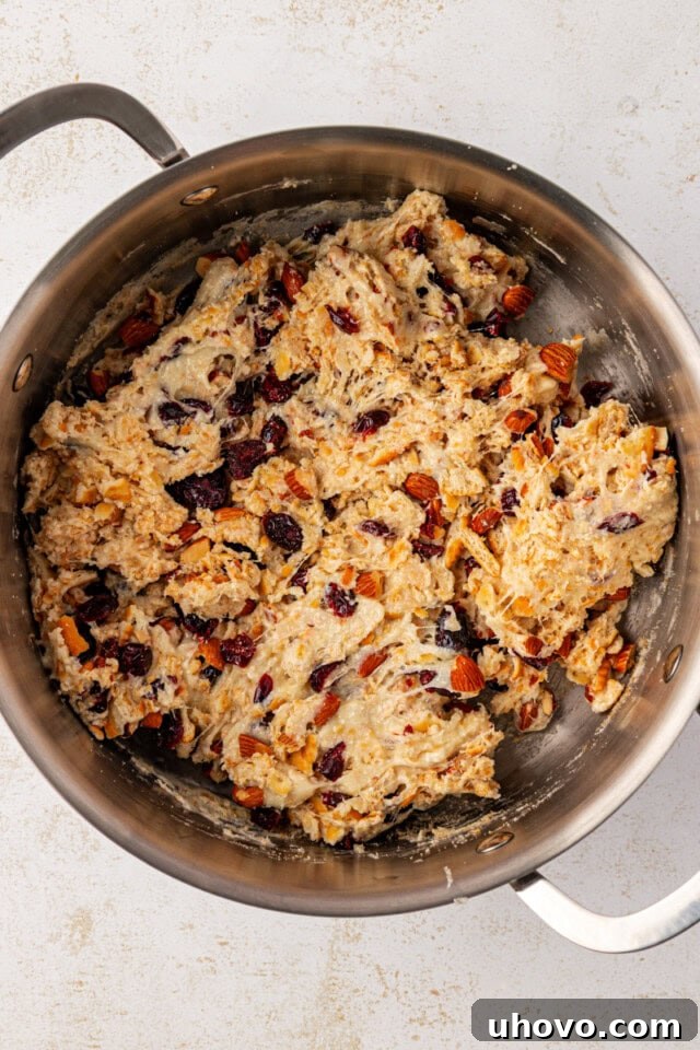 Close-up overhead view of the Snowflake Crisp mixture in a large saucepan, with all add-ins evenly combined into the creamy base.
