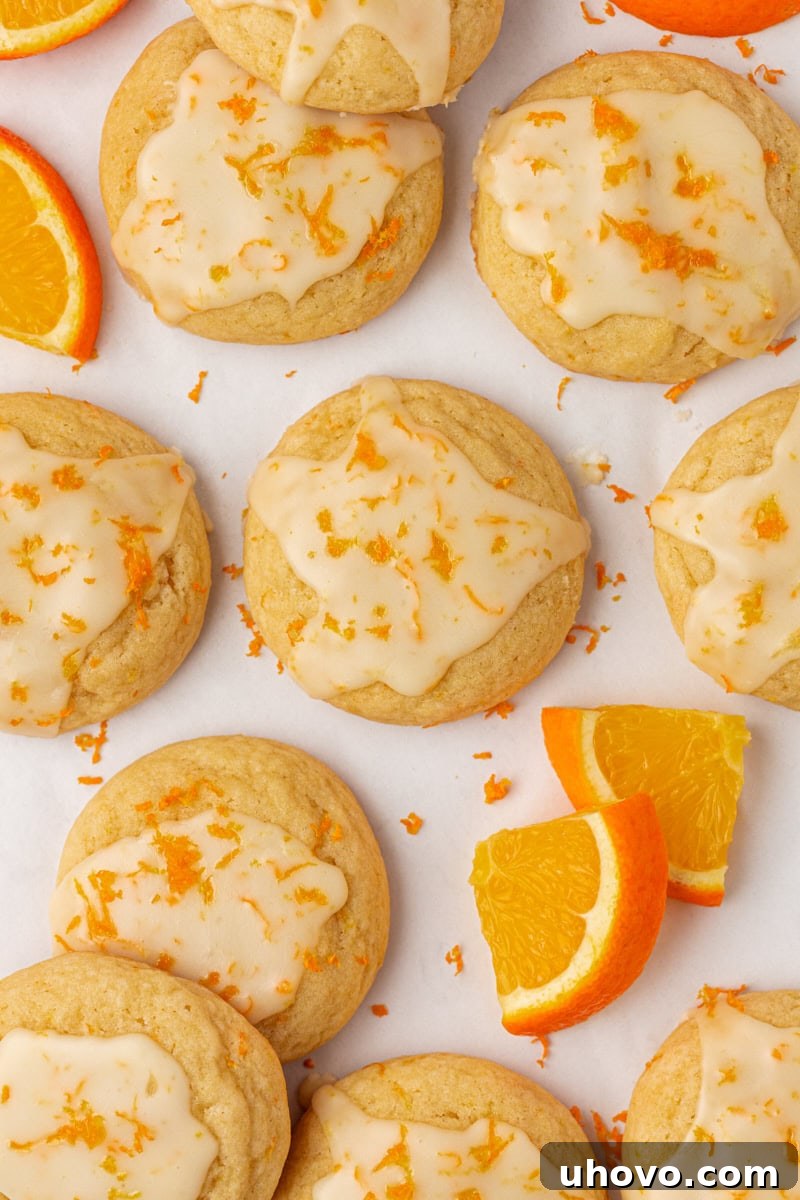 overhead view of glazed orange cookies on a white surface