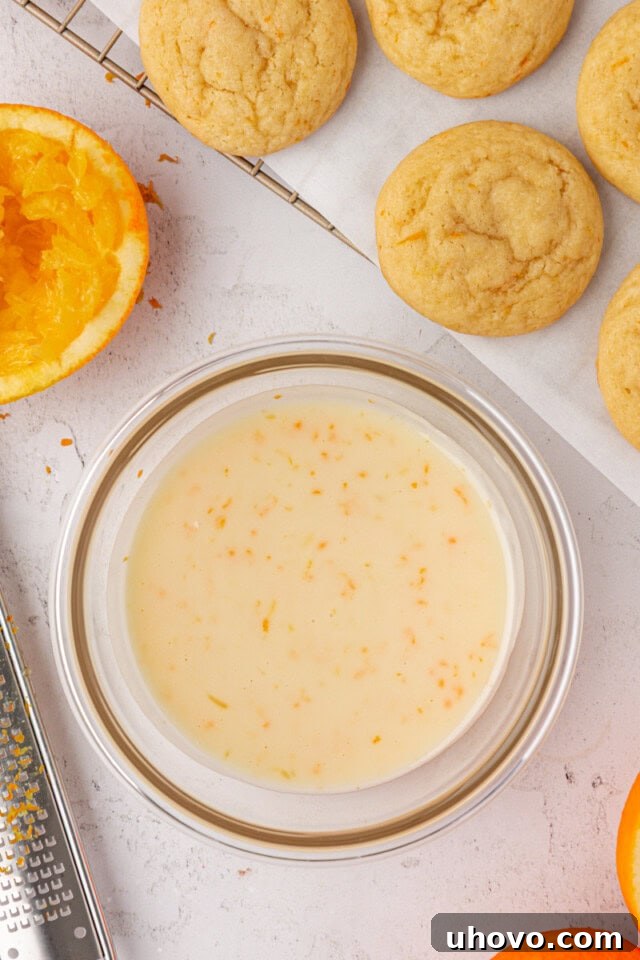 overhead view of orange icing in a glass bowl