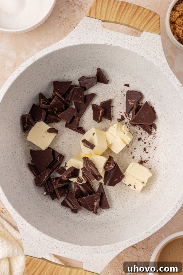 overhead view of chopped chocolate and butter in a saucepan