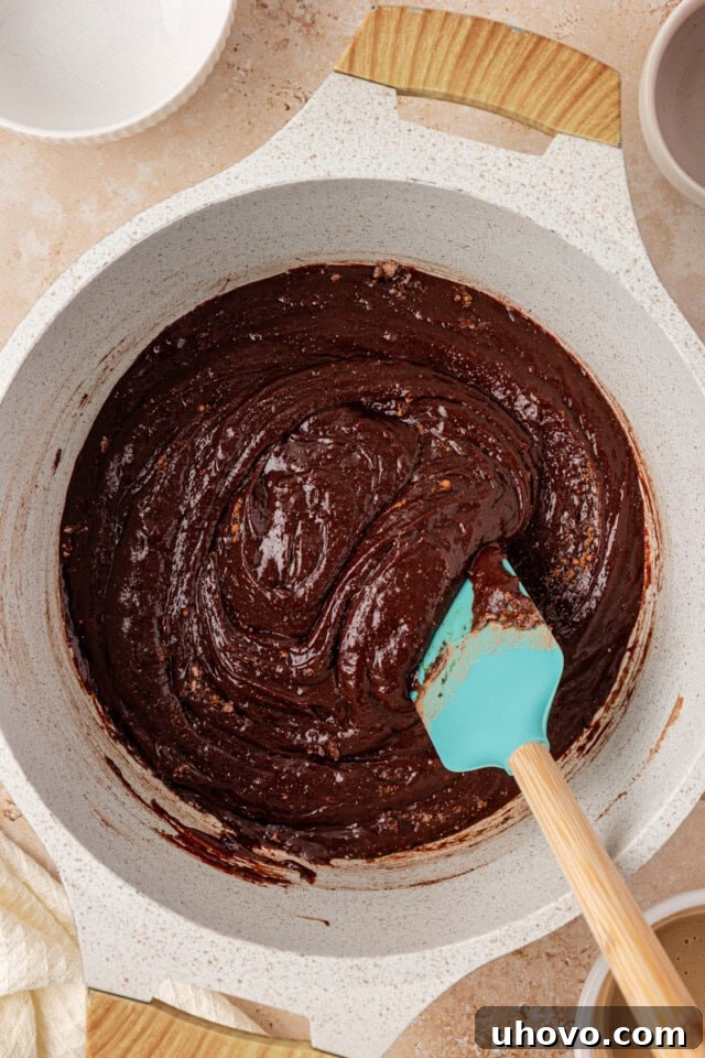 overhead view of tahini brownie batter in a saucepan