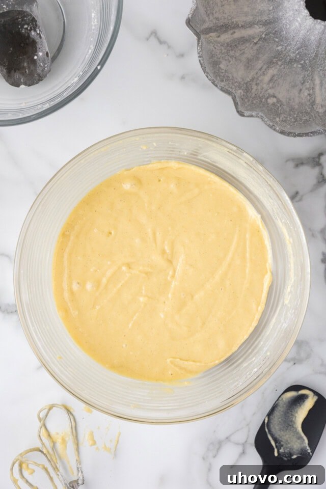 overhead view of vanilla cake batter in a mixing bowl