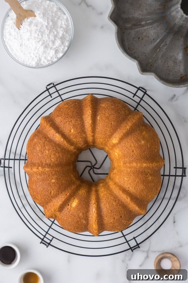 overhead view of freshly baked vanilla Bundt cake cooling on a wire rack