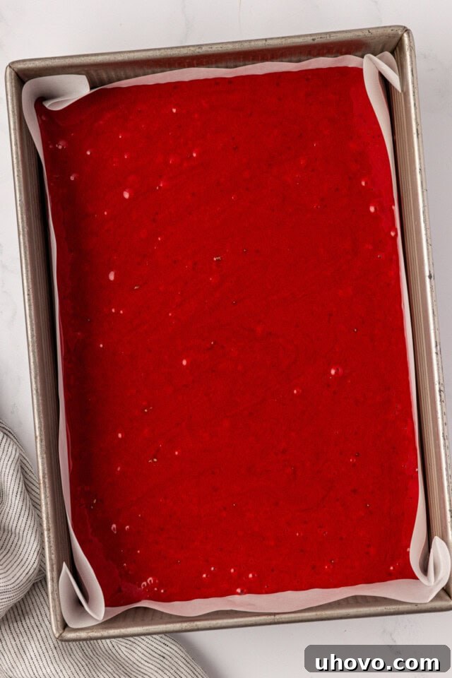 overhead view of red velvet sheet cake in a 9x13 pan ready to go into the oven