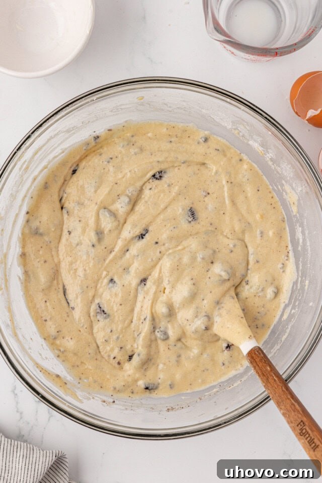 overhead view of cookies and cream cupcake batter in a glass mixing bowl
