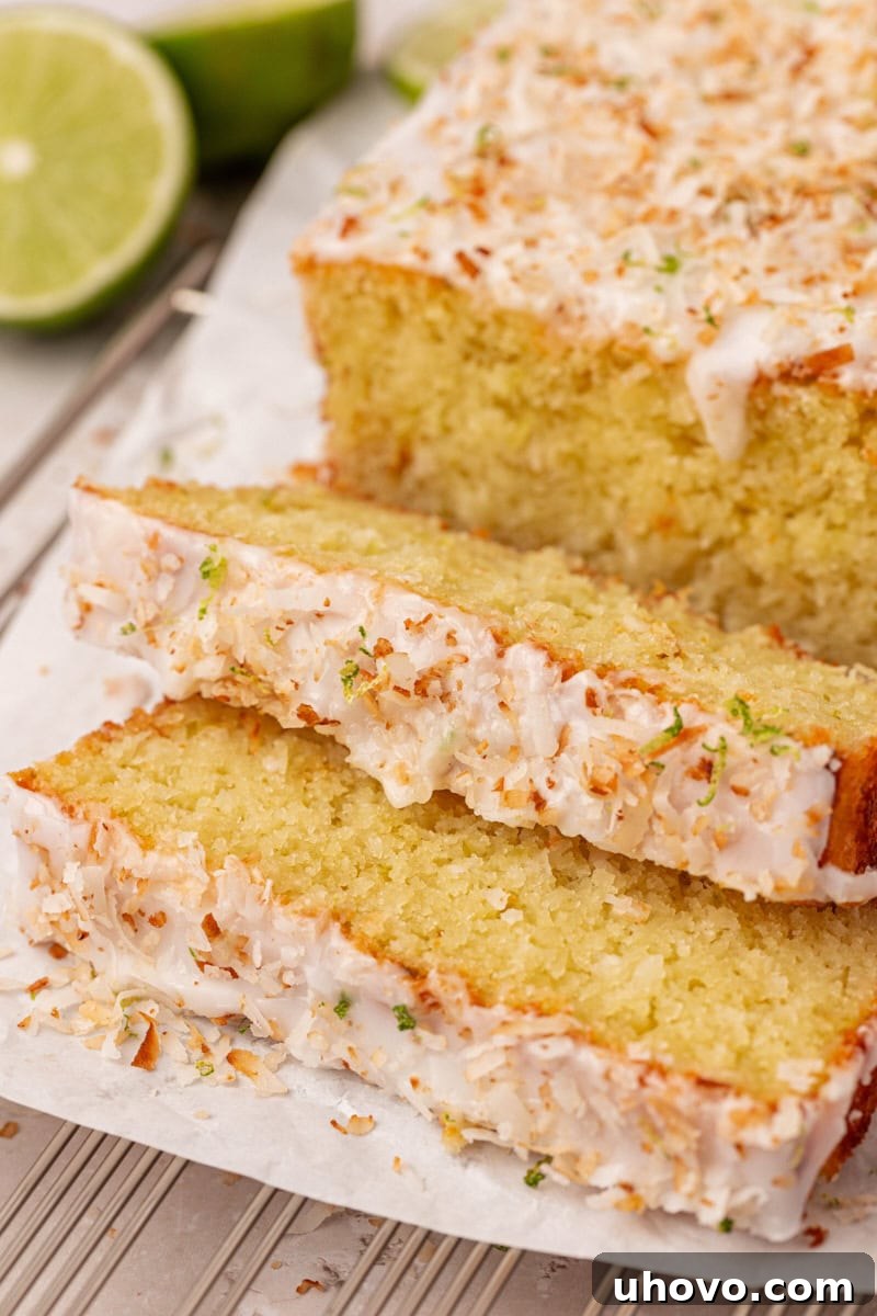 Close-up of coconut lime loaf cake with shredded coconut throughout, showing soft texture