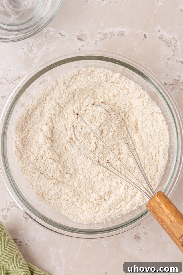 Flour, baking powder, baking soda, and salt whisked together in a mixing bowl