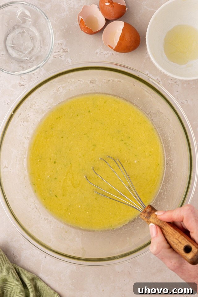 Melted butter, oil, eggs, coconut milk, sour cream, lime juice, and coconut extract combined in a mixing bowl