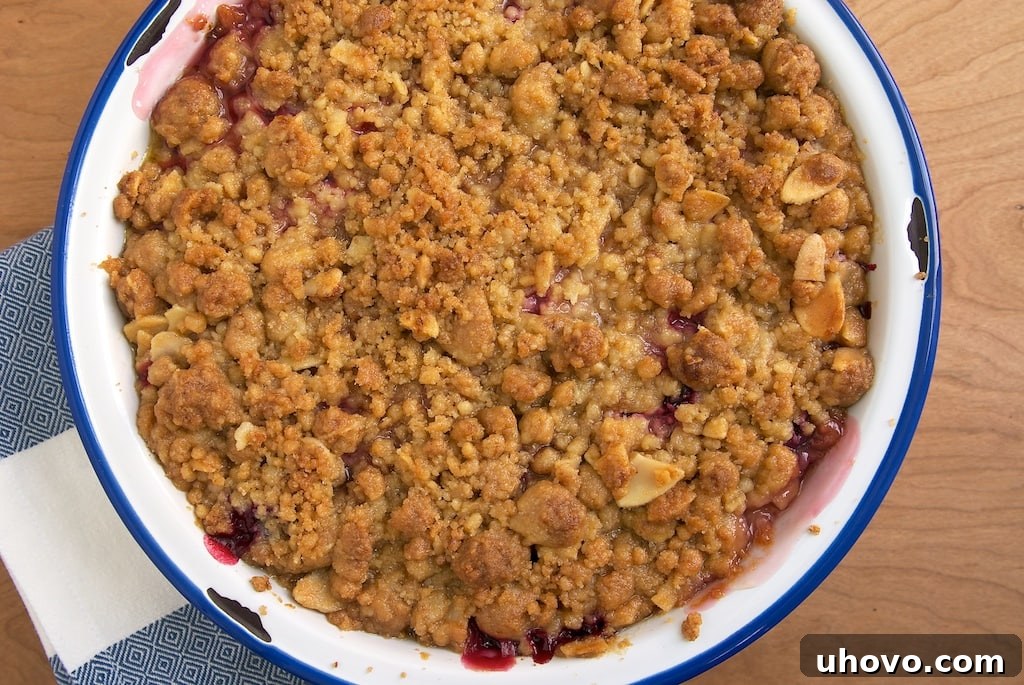 A delicious Pear and Plum Crumble, showcasing a golden oat topping over bubbling fruit. Perfect for a cozy fall dessert.