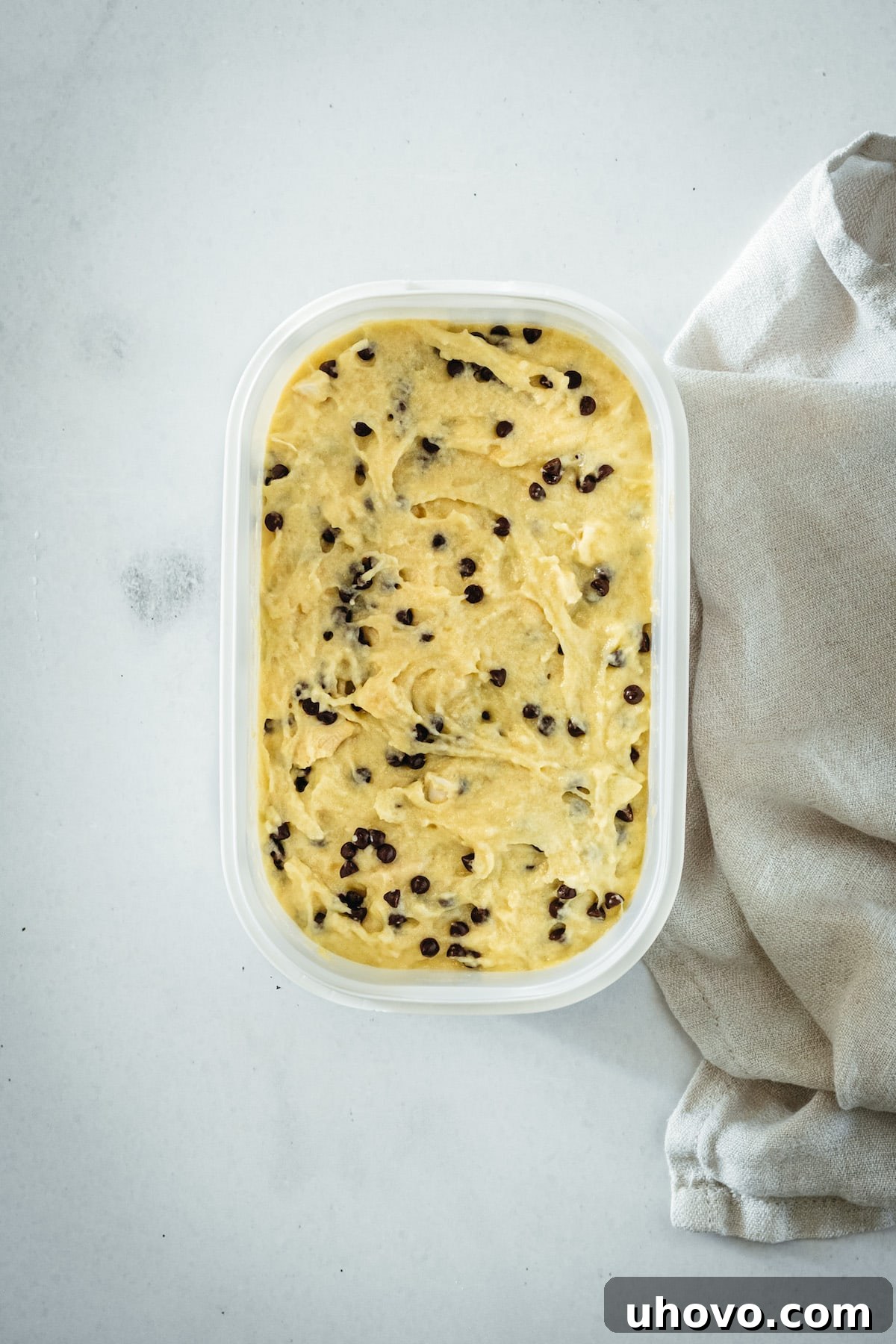 An overhead shot of the finished Chocolate Chip Cashew Bread batter in a mixing bowl, rich with chocolate chips and chopped cashews, ready to be poured into the pan.